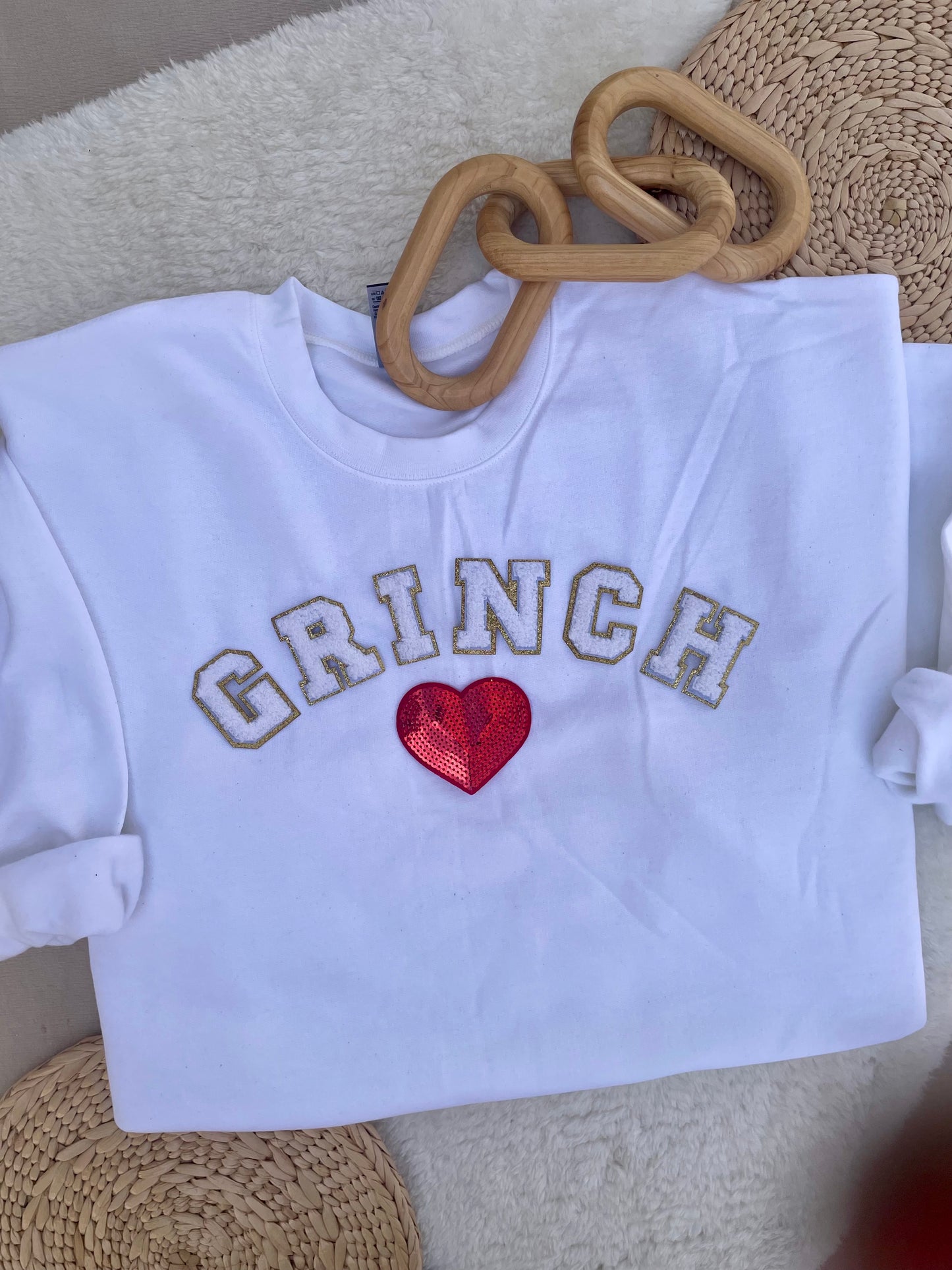 Arched white Grinch varsity letters with sequin heart pullover