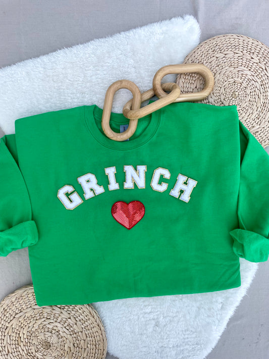 Arched white Grinch varsity letters with sequin heart pullover